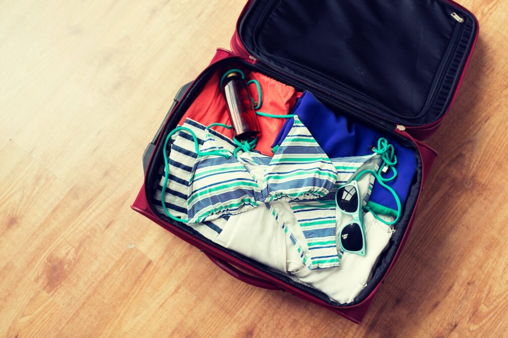 close up of travel bag with beach clothes